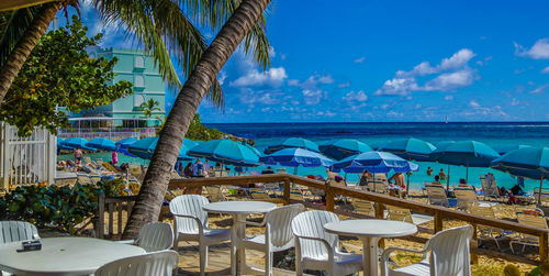 View of swimming pool at beach against blue sky