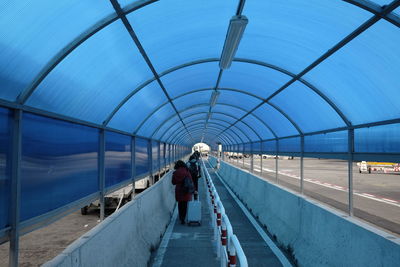 Rear view of people walking at airport