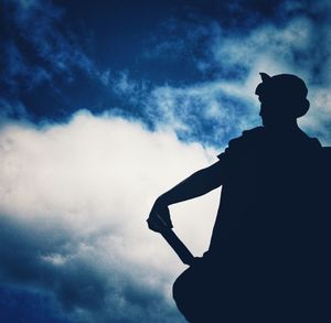 Low angle view of silhouette man against sky