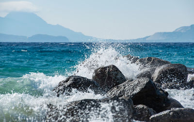 Waves at storm in mediterranean sea beating on breakwater on kos greece