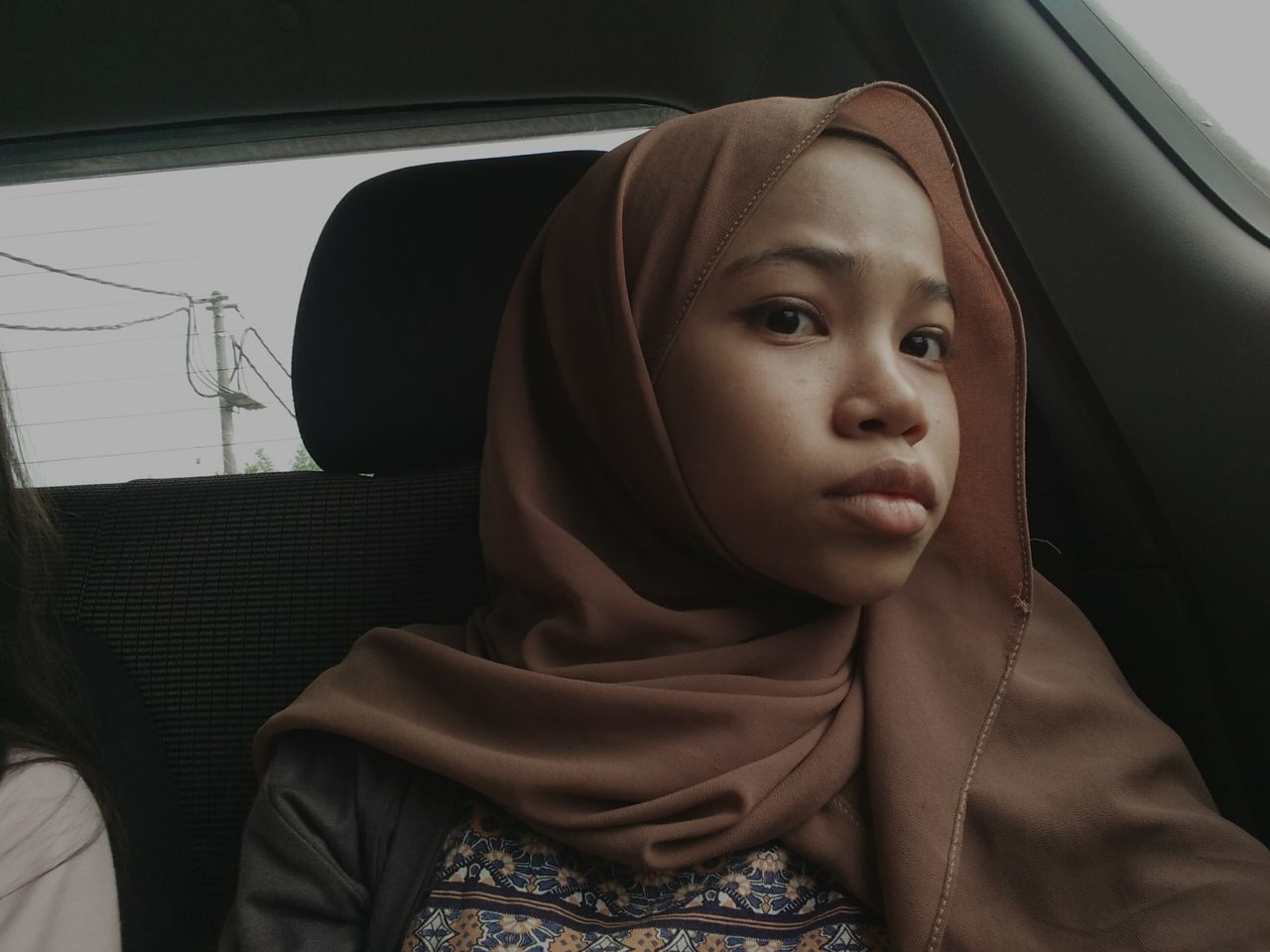 PORTRAIT OF WOMAN IN CAR