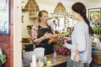 Female customer talking with cashier at health food store