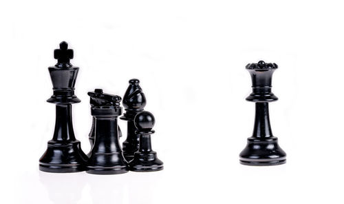 View of chess pieces against white background