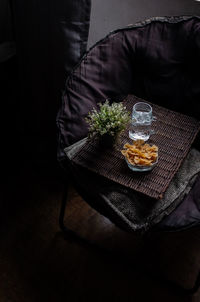 High angle view of farfalle pasta and drinking water on wicker mat