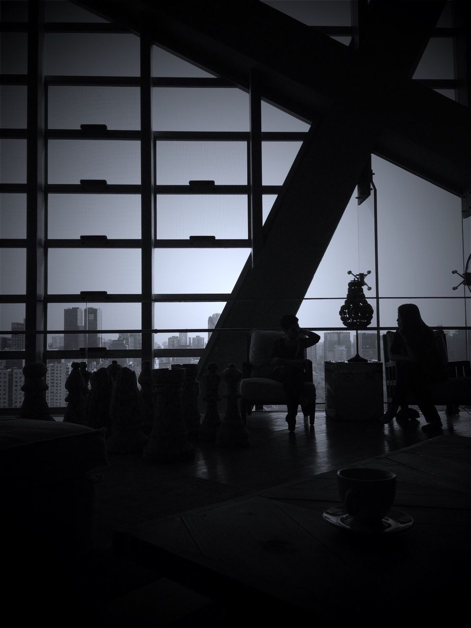 indoors, glass - material, silhouette, window, architecture, built structure, transparent, men, lifestyles, person, leisure activity, sky, medium group of people, reflection, incidental people, glass, airport, table, sunlight