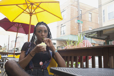 A young woman eating frozen yoghurt.