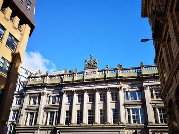 Low angle view of building against blue sky