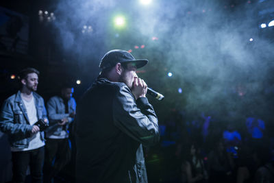 People enjoying music concert at night