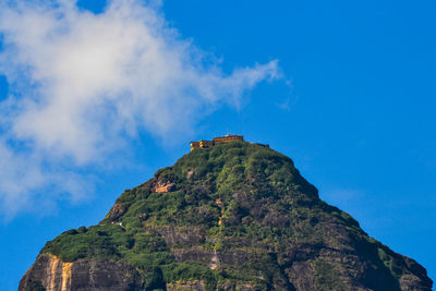 Low angle view of rock formation against sky