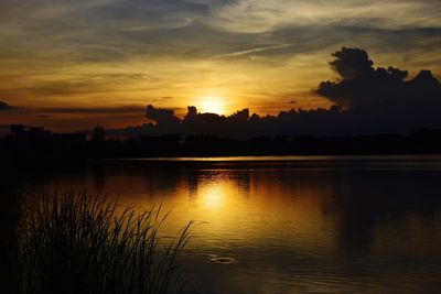 Scenic view of lake against orange sky