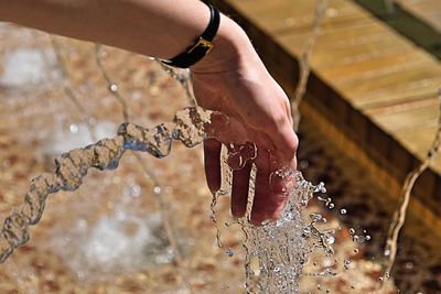 Close-up of hand splashing water