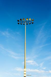 Low angle view of sign against blue sky