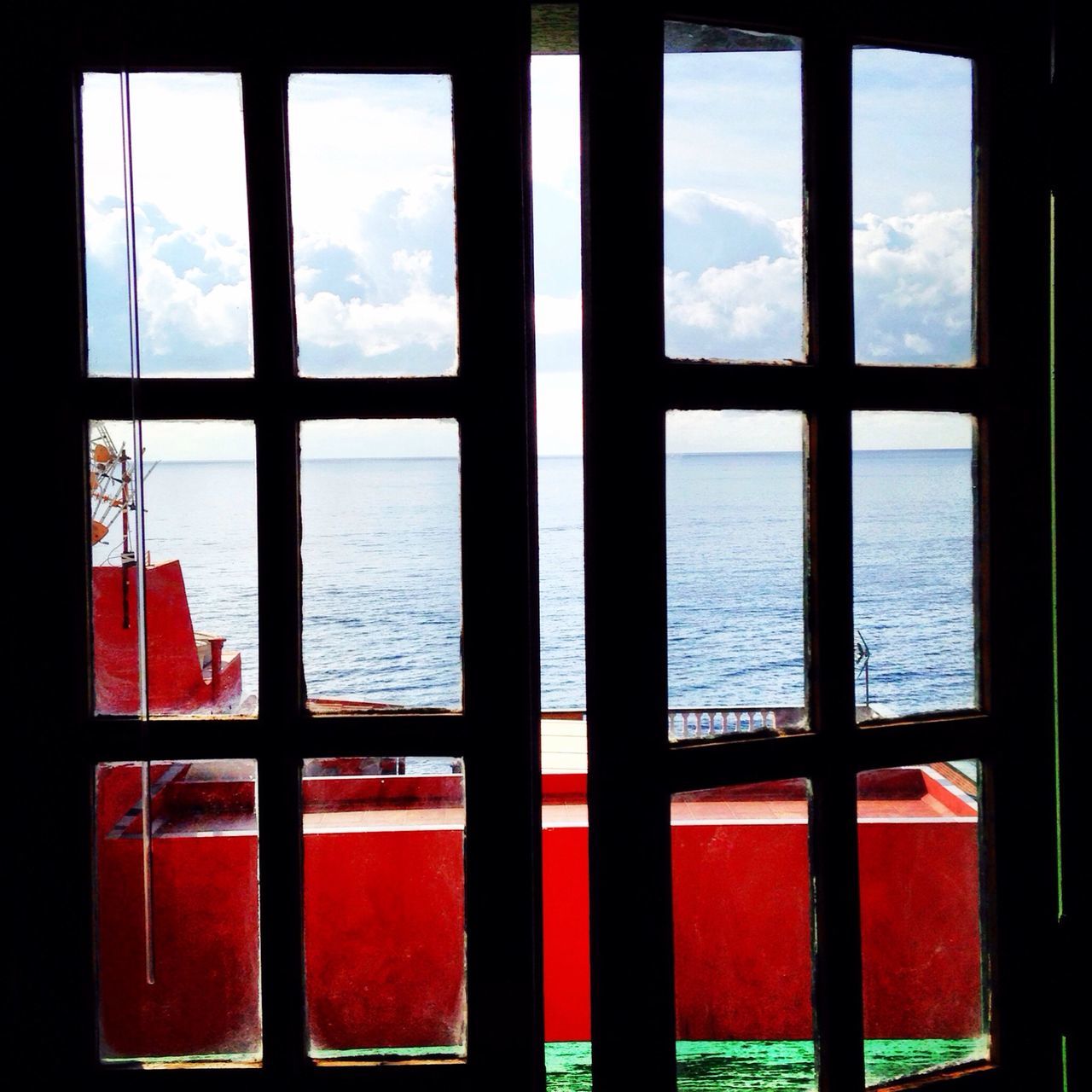 sea, window, water, sky, horizon over water, indoors, built structure, architecture, transparent, glass - material, nature, no people, day, scenics, sunset, tranquil scene, cloud - sky, cloud, nautical vessel, sunlight