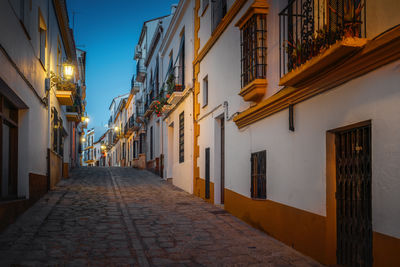 Street amidst buildings at night