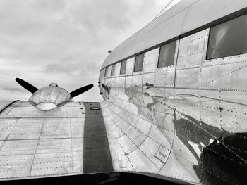 Low angle view of airplane flying against sky