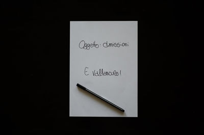 Close-up of text on paper against black background