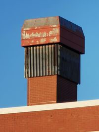 Low angle view of building against clear blue sky