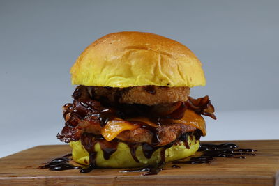 Close-up of burger on table against gray background