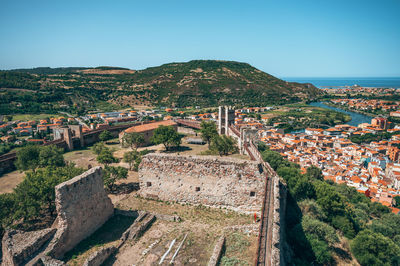 High angle view of townscape by sea against clear sky