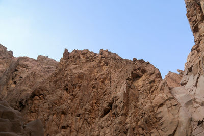 Low angle view of rock formations against sky