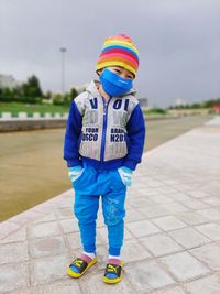 Full length of boy standing on footpath