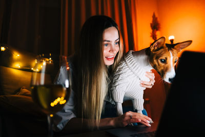 Young woman looking at dog