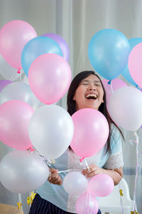 Happy woman holding balloons