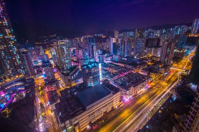 High angle view of illuminated city buildings at night