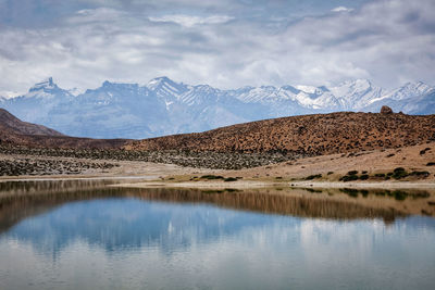 Scenic view of lake and mountains against sky