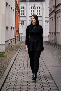 Full length of woman walking on street