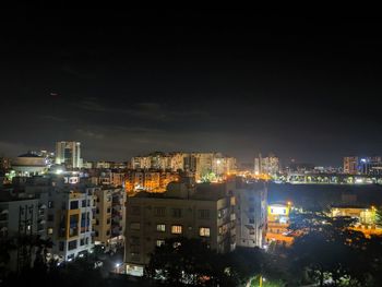 High angle view of illuminated buildings in city at night