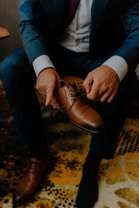 Low section of man sitting at sidewalk