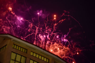 Low angle view of illuminated building against sky at night