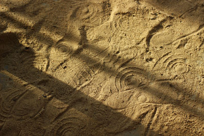 High angle view of footprints on sand