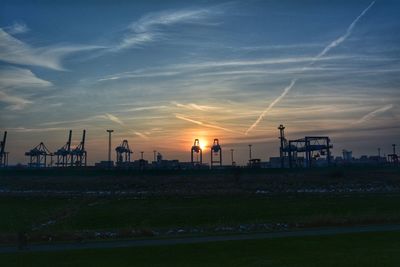 Scenic view of silhouette field against sky during sunset