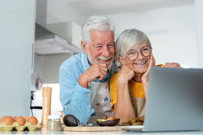Portrait of young woman using laptop at home