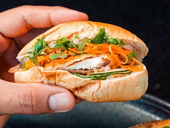 Close-up of hand holding burger