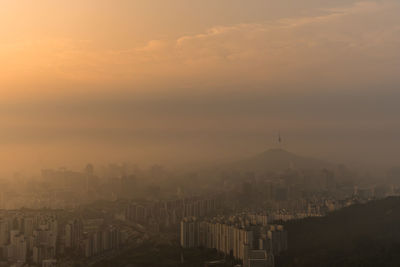 High angle view of buildings in city during sunset