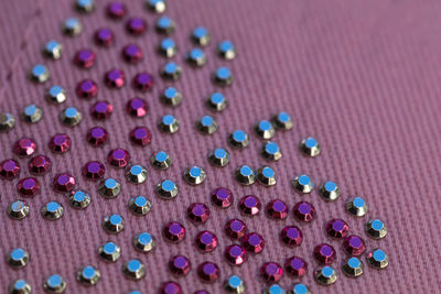 Close-up of sequins on pink fabric