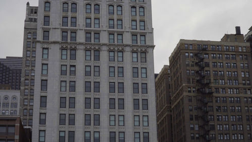 Low angle view of buildings in city against sky