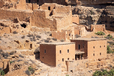 Scenic view of old stone houses, palm trees ghoufi canyon in the aures region, algeria