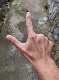 Midsection of human feet on rock