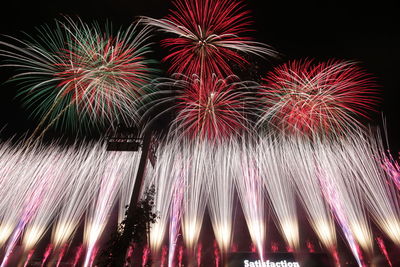 Low angle view of firework display at night