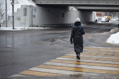 Rear view of man walking on street