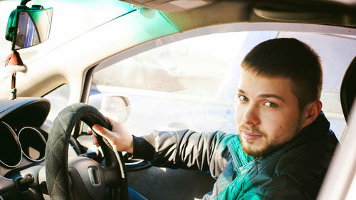 Portrait of man sitting in car