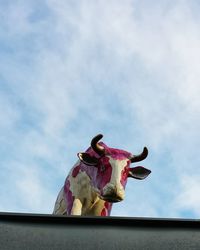 Low angle view of cow sculpture against sky