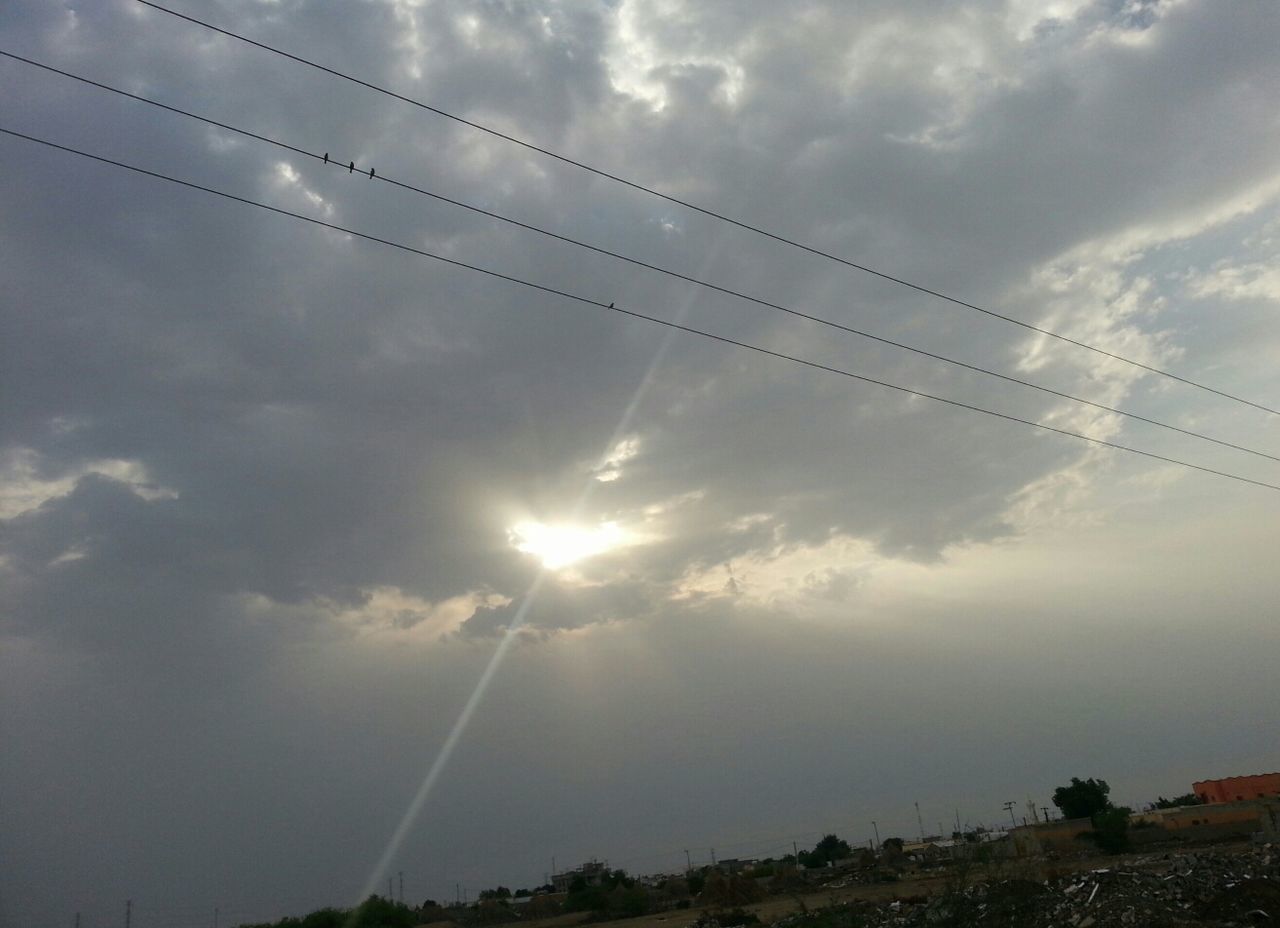 sky, power line, electricity pylon, cloud - sky, sun, cable, sunbeam, electricity, connection, cloudy, power supply, low angle view, tranquility, sunlight, scenics, beauty in nature, tranquil scene, silhouette, nature, cloud