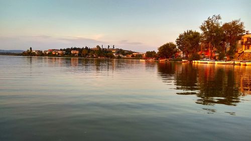 Scenic view of lake against sky at sunset