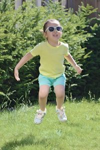 Full length of boy wearing sunglasses on field