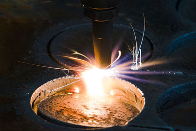 Close-up of lit candle on table